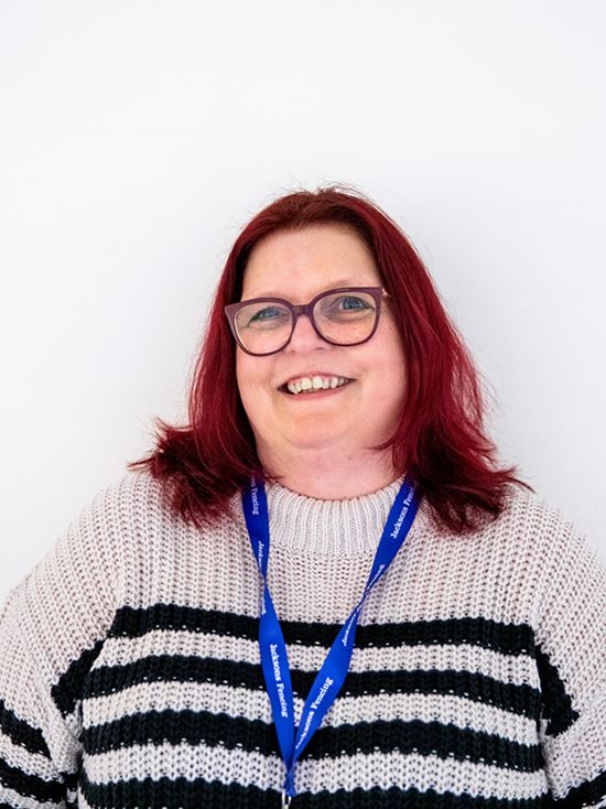 A woman with glasses and red hair