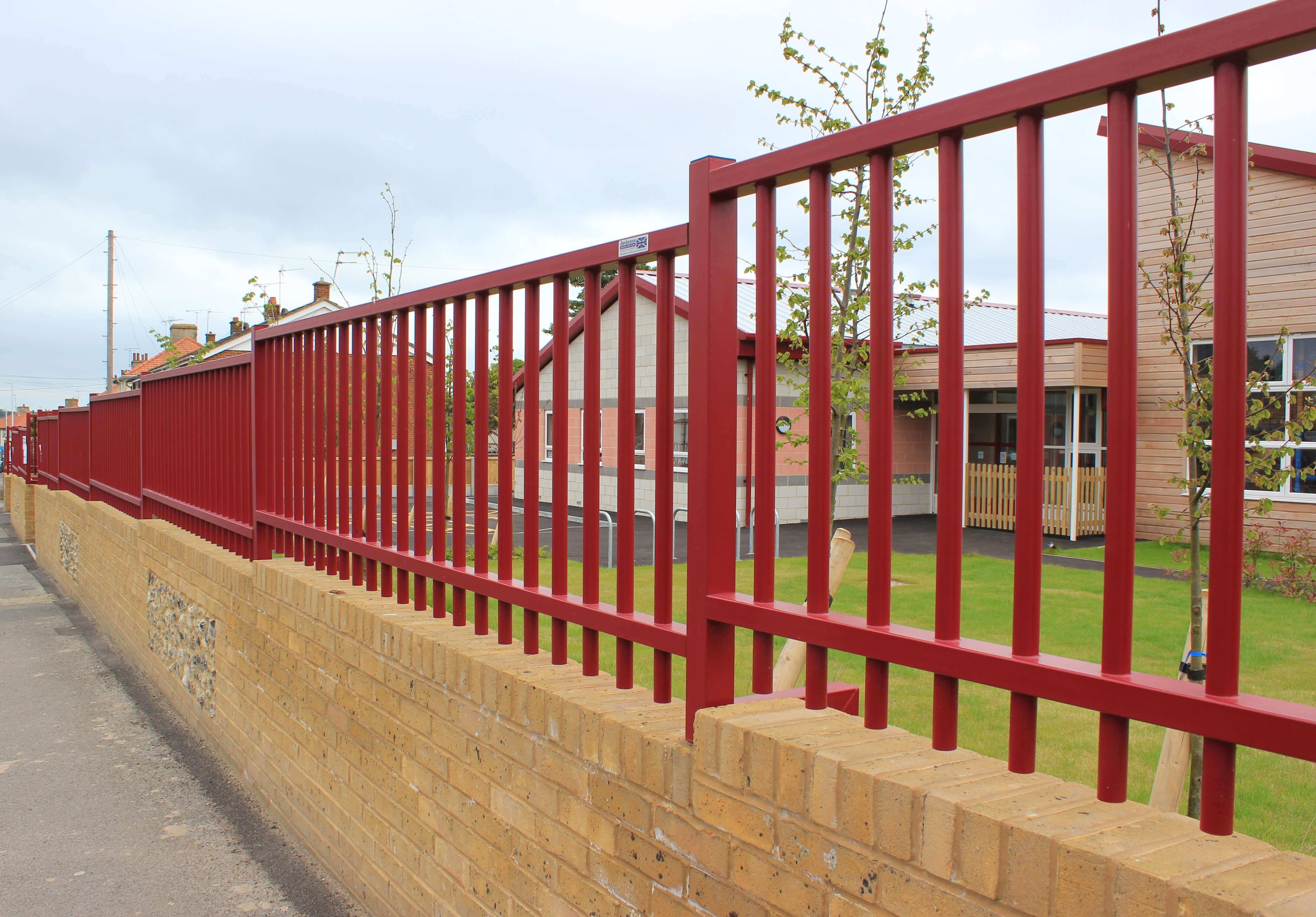 Sentry Fencing on top of wall maroon powder coated finish