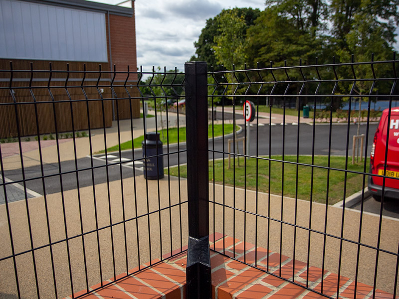 Cranked posts mesh fencing on wall