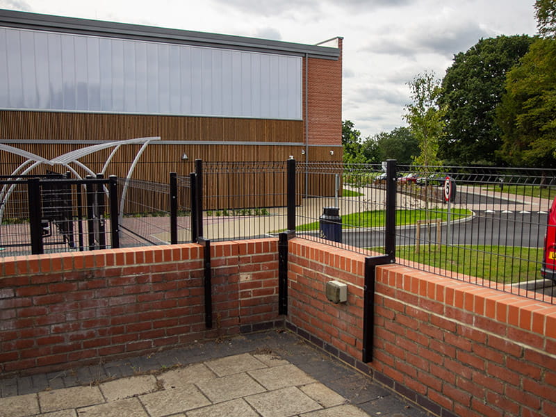 Mesh fencing on wall with cranked posts