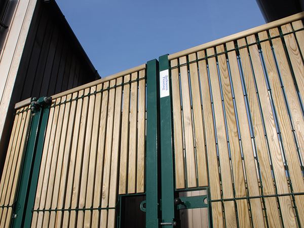 Mesh gates with timber pales