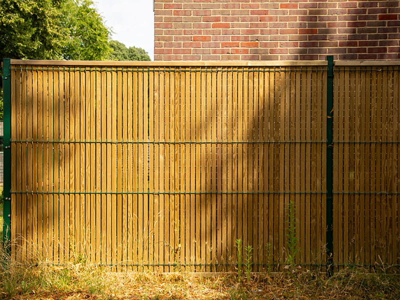 Green mesh fencing timber slats