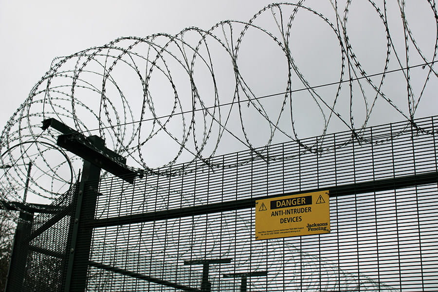 Barbed tape security topping