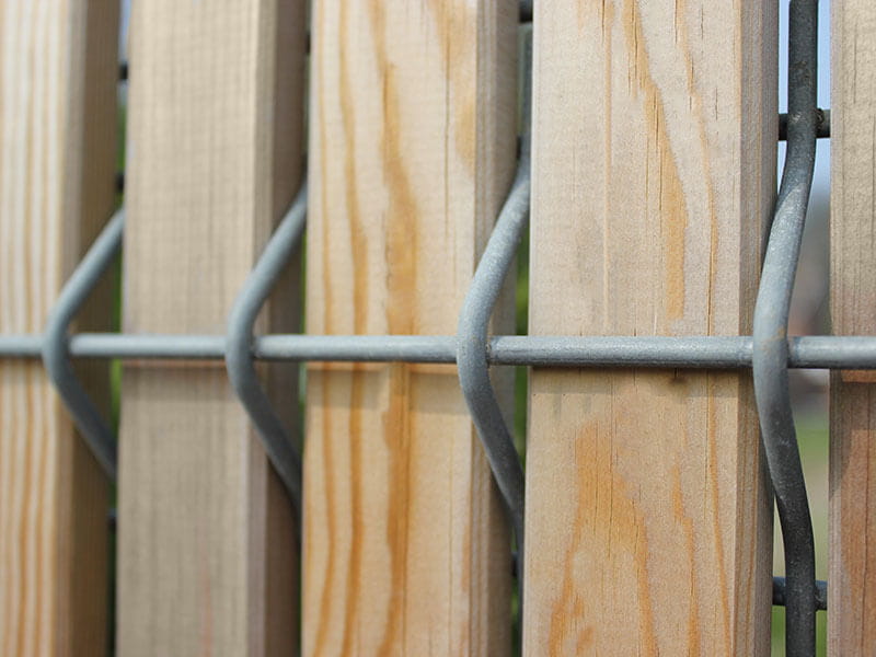 Mesh fencing with timber slats