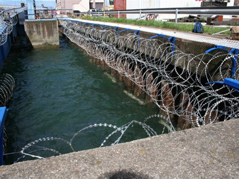 Concertina razor wire around harbour