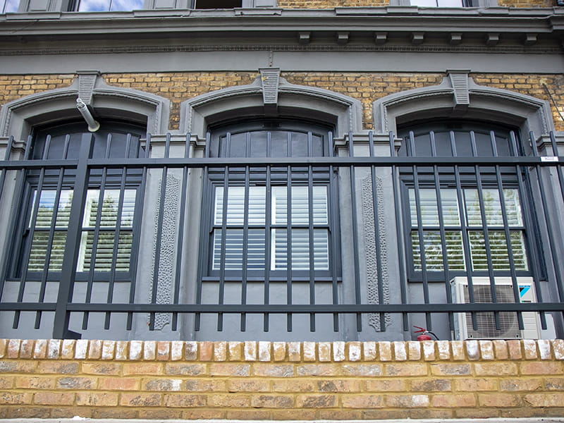 Grey steel railings on wall