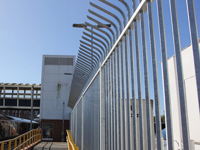 Security fence with integrated topping
