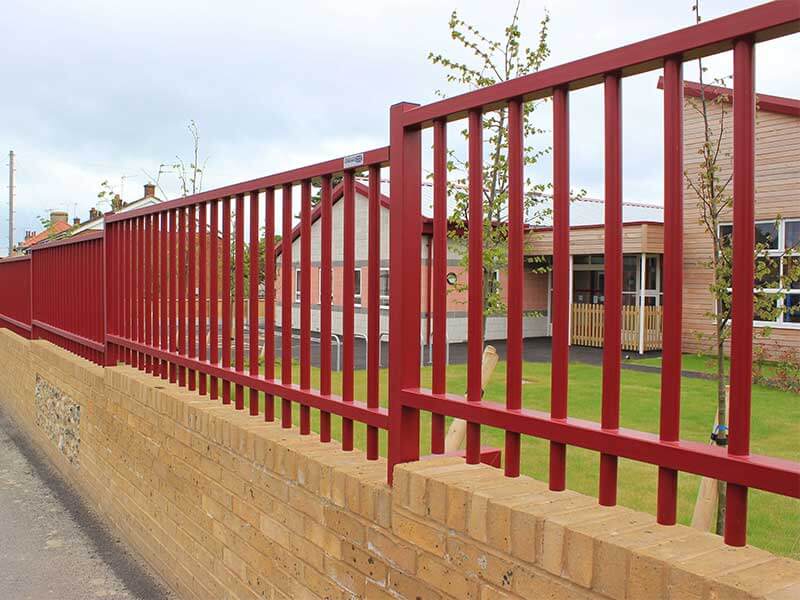 Sentry Fencing on top of wall maroon powder coated finish